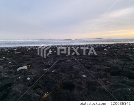 Ocean shoreline with black sand beach, spectacular panoramic view of nature and wilderness with waves crashing on beachfront. Frozen coastline in Iceland with wonderful scenery and rocks. Ocean shoreline with black sand beach, spectacular panoramic view of nature and wilderness with waves crashing on beachfront. Frozen coastline in Iceland with wonderful scenery and rocks. 120686541