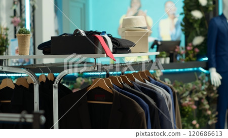 Fashion retail store displaying an assortment of chic seasonal clothes from a famous designer at a store, inviting customers to explore stylish options and elevate their wardrobes. Fashion retail store displaying an assortment of chic seasonal clothes from a famous designer at a store, inviting customers to explore stylish options and elevate their wardrobes. 120686613