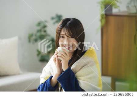 Young woman relaxing in a room Young woman relaxing in a room 120686805