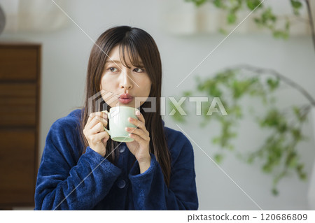 Young woman relaxing in a room Young woman relaxing in a room 120686809