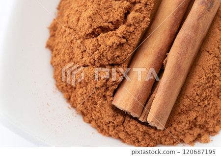 Cinnamon powder and cinnamon sticks close-up 120687195