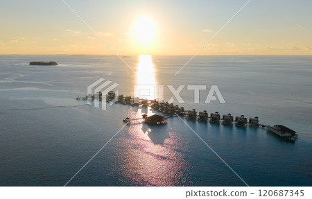 Aerial views of Velavaru Island at sunset in Maldives 120687345