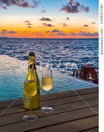 Sunset views from overwater pool villa in Maldives 120687390