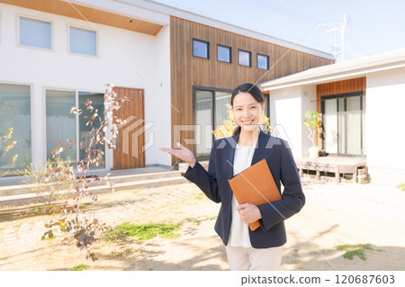 站在房子前面的房地產銷售人員 站在房子前面的房地產銷售人員 120687603