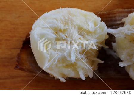 Cross section of a cut banana on a table Cross section of a cut banana on a table 120687678