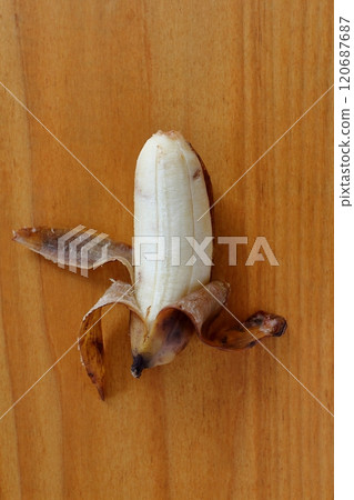 Peeled banana on a table Peeled banana on a table 120687687