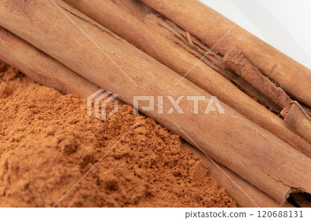 Cinnamon powder and cinnamon sticks close-up Cinnamon powder and cinnamon sticks close-up 120688131