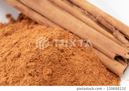 Cinnamon powder and cinnamon sticks close-up Cinnamon powder and cinnamon sticks close-up 120688132