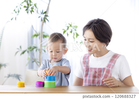Nursery school children playing with their teachers 120688327