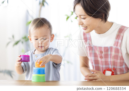 Nursery school children playing with their teachers 120688334