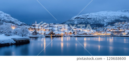 Snowy Christmas village by the calm lake at dusk 120688600