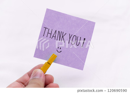 Thank you note handheld gesture personal connection minimalistic setting close-up view business appreciation concept 120690590