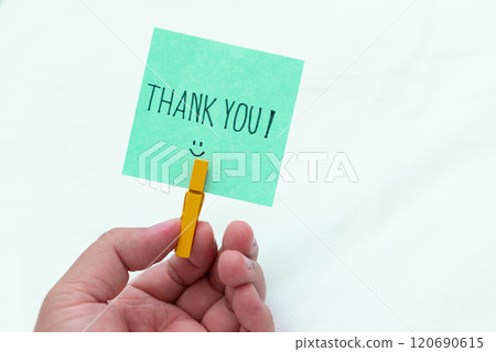 Thank you note in hand business context emotional connection simple setup close-up view gratitude in the workplace 120690615