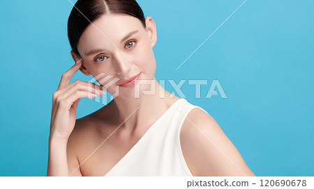 Beautiful young woman with clean fresh skin on blue background, Face care, Facial treatment, Cosmetology, beauty and spa, women portrait. Beautiful young woman with clean fresh skin on blue background, Face care, Facial treatment, Cosmetology, beauty and spa, women portrait. 120690678
