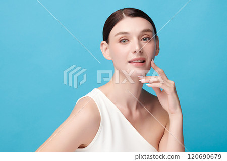Beautiful young woman with clean fresh skin on blue background, Face care, Facial treatment, Cosmetology, beauty and spa, women portrait. 120690679