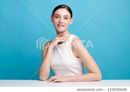 Beautiful young woman with clean fresh skin on blue background, Face care, Facial treatment, Cosmetology, beauty and spa, women portrait. Beautiful young woman with clean fresh skin on blue background, Face care, Facial treatment, Cosmetology, beauty and spa, women portrait. 120690686
