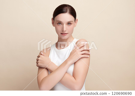 Beautiful young woman with clean fresh skin on beige background, Face care, Facial treatment, Cosmetology, beauty and spa, women portrait. 120690690