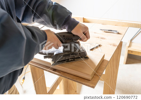 Sanding the surface of cedar boards 120690772