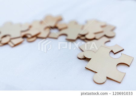 Puzzle pieces representing business strategy workspace visual concept engaging environment close-up collaboration and problem solving 120691033