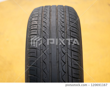 Inspecting tire quality automotive workshop product photography industrial setting close-up safety awareness 120691167