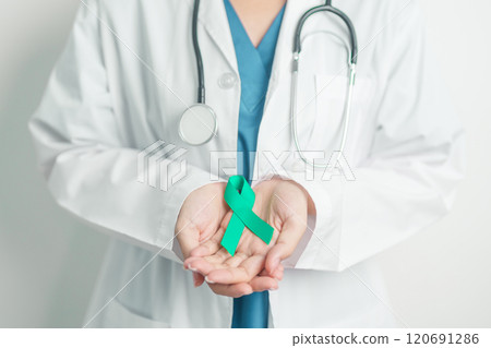 Doctor holding Teal Ribbon for January Cervical Cancer Awareness month. Uterus and Ovaries, Cervix, Endometriosis, Hysterectomy, Uterine fibroids, Reproductive, Healthcare and World cancer day 120691286
