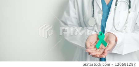 Doctor holding Teal Ribbon for January Cervical Cancer Awareness month. Uterus and Ovaries, Cervix, Endometriosis, Hysterectomy, Uterine fibroids, Reproductive, Healthcare and World cancer day 120691287