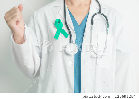 Doctor holding Teal Ribbon for January Cervical Cancer Awareness month. Uterus and Ovaries, Cervix, Endometriosis, Hysterectomy, Uterine fibroids, Reproductive, Healthcare and World cancer day 120691294