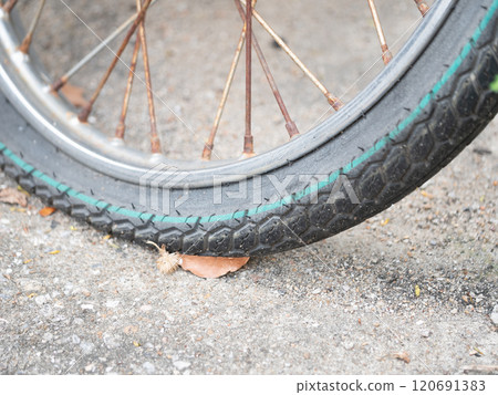 Flat bicycle tire urban street close-up photography city environment ground level transportation maintenance 120691383