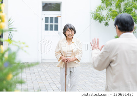Senior couple walking in the garden Senior couple walking in the garden 120691485