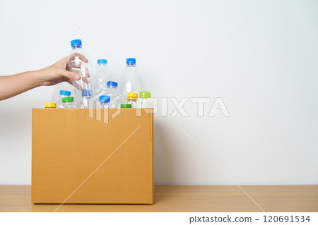 Volunteer keep plastic bottle into paper box at home or office. Hand Sorting Recycle garbage. Ecology, Environmental, pollution, Dispose recycling, waste management and trash Separation concept Volunteer keep plastic bottle into paper box at home or office. Hand Sorting Recycle garbage. Ecology, Environmental, pollution, Dispose recycling, waste management and trash Separation concept 120691534