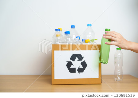 Volunteer keep plastic bottle into paper box at home or office. Hand Sorting Recycle garbage. Ecology, Environmental, pollution, Dispose recycling, waste management and trash Separation concept Volunteer keep plastic bottle into paper box at home or office. Hand Sorting Recycle garbage. Ecology, Environmental, pollution, Dispose recycling, waste management and trash Separation concept 120691539