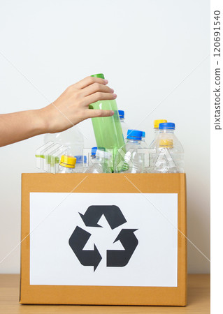Volunteer keep plastic bottle into paper box at home or office. Hand Sorting Recycle garbage. Ecology, Environmental, pollution, Dispose recycling, waste management and trash Separation concept Volunteer keep plastic bottle into paper box at home or office. Hand Sorting Recycle garbage. Ecology, Environmental, pollution, Dispose recycling, waste management and trash Separation concept 120691540