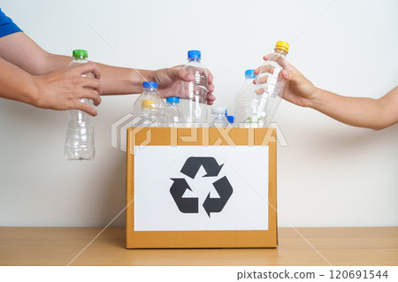 Volunteer keep plastic bottle into paper box at home or office. Hand Sorting Recycle garbage. Ecology, Environmental, pollution, Dispose recycling, waste management and trash Separation concept 120691544