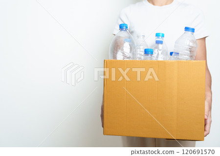 Volunteer keep plastic bottle into paper box at home or office. Hand Sorting Recycle garbage. Ecology, Environmental, pollution, Dispose recycling, waste management and trash Separation concept Volunteer keep plastic bottle into paper box at home or office. Hand Sorting Recycle garbage. Ecology, Environmental, pollution, Dispose recycling, waste management and trash Separation concept 120691570