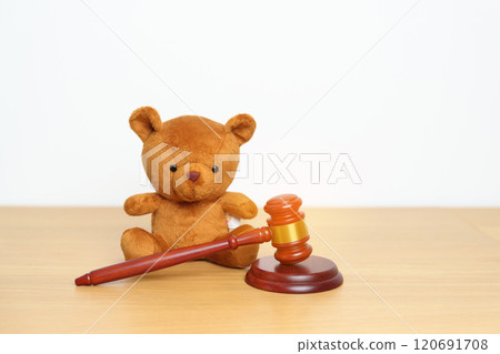 Children, Kid and Family Law concepts. toy bear with gavel justice hammer on desk in courthouse. 120691708