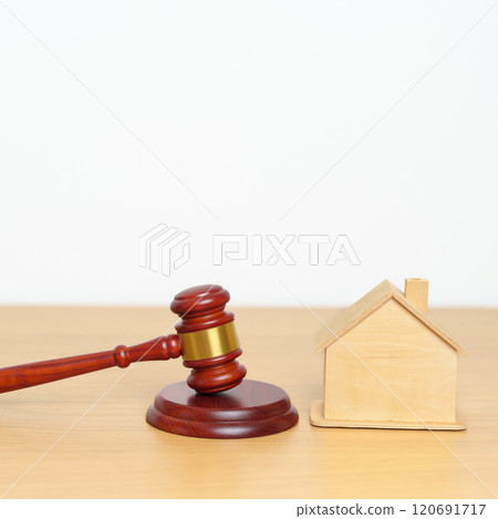 Real Estate Law, Home Insurance, property Tax, Auction and Bidding concepts. small toy house model with gavel justice hammer on desk in courthouse. Real Estate Law, Home Insurance, property Tax, Auction and Bidding concepts. small toy house model with gavel justice hammer on desk in courthouse. 120691717