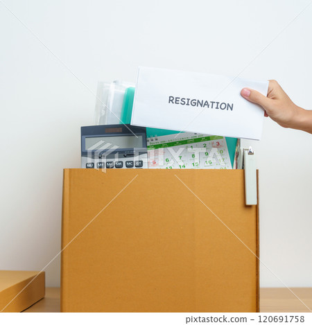 Resignation, Layoff, Unemployment, Dismiss, Job quit, Jobless and Farewell concept. Businesswoman holding letter of Resign contract with documents cardboard box at office 120691758