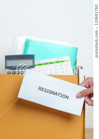 Resignation, Layoff, Unemployment, Dismiss, Job quit, Jobless and Farewell concept. Businessman holding letter of Resign contract with documents cardboard box at office 120691760
