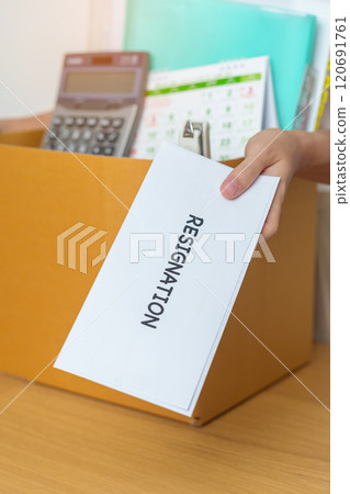 Resignation, Layoff, Unemployment, Dismiss, Job quit, Jobless and Farewell concept. Businesswoman holding letter of Resign contract with documents cardboard box at office Resignation, Layoff, Unemployment, Dismiss, Job quit, Jobless and Farewell concept. Businesswoman holding letter of Resign contract with documents cardboard box at office 120691761