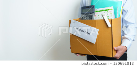 Resignation, Layoff, Unemployment, Dismiss, Job quit, Jobless and Farewell concept. Businessman holding letter of Resign contract with documents cardboard box at office 120691818