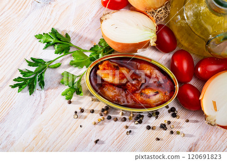 Stuffed squid in tomato sauce on background with greens, tomatoes 120691823