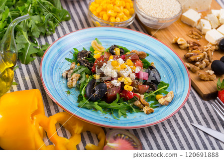 Salad with arugula, olives, Feta cheese, corn and walnut and its ingredients 120691888