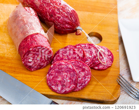 Sliced Iberian dry cured salchichon from pork meat without paprika 120691923