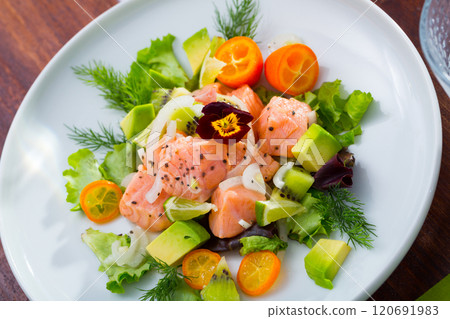 Ceviche from salmon on plate with cumquat, green dill and avocado 120691983
