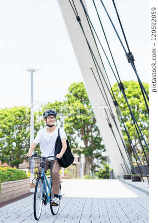 A young man riding a bicycle A young man riding a bicycle 120692059
