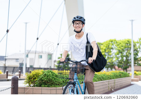 A man riding a bicycle A man riding a bicycle 120692060