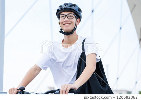 A man riding a bicycle 120692062