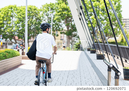 A man riding a bicycle A man riding a bicycle 120692071