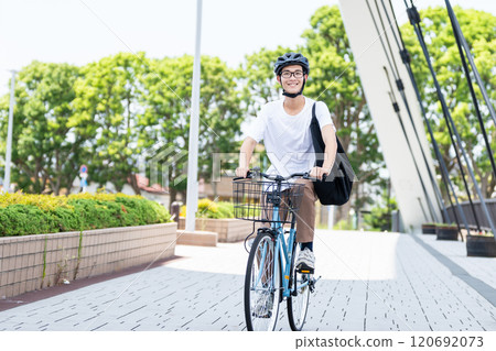 A man riding a bicycle 120692073