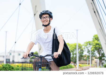 A man riding a bicycle 120692078